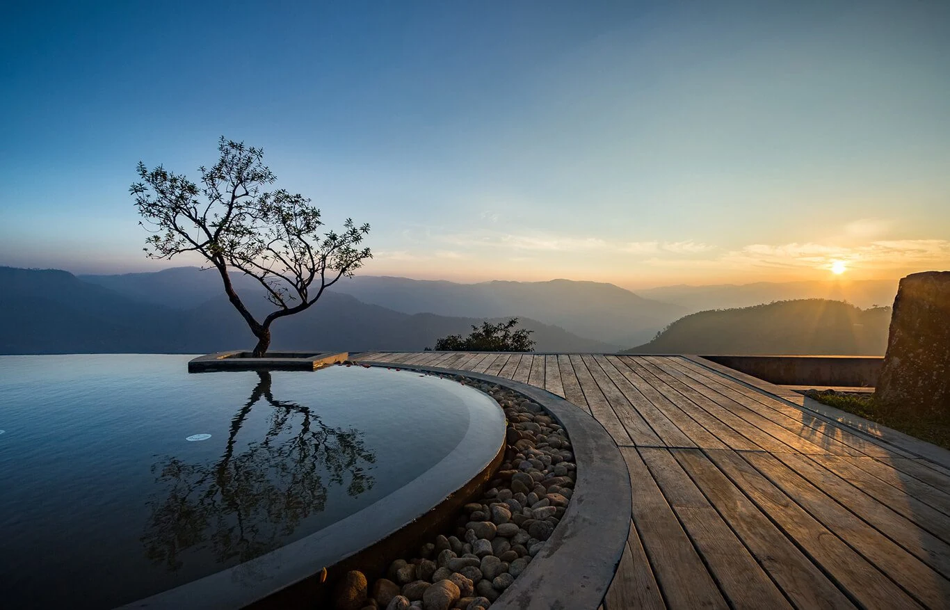 Infinity pool overlooking mountain hills at Prakriti Shakti